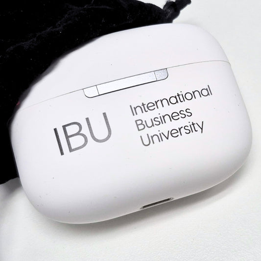 Close-up of the IBU Truly Wireless Earbuds charging case with the International Business University logo printed on it.
